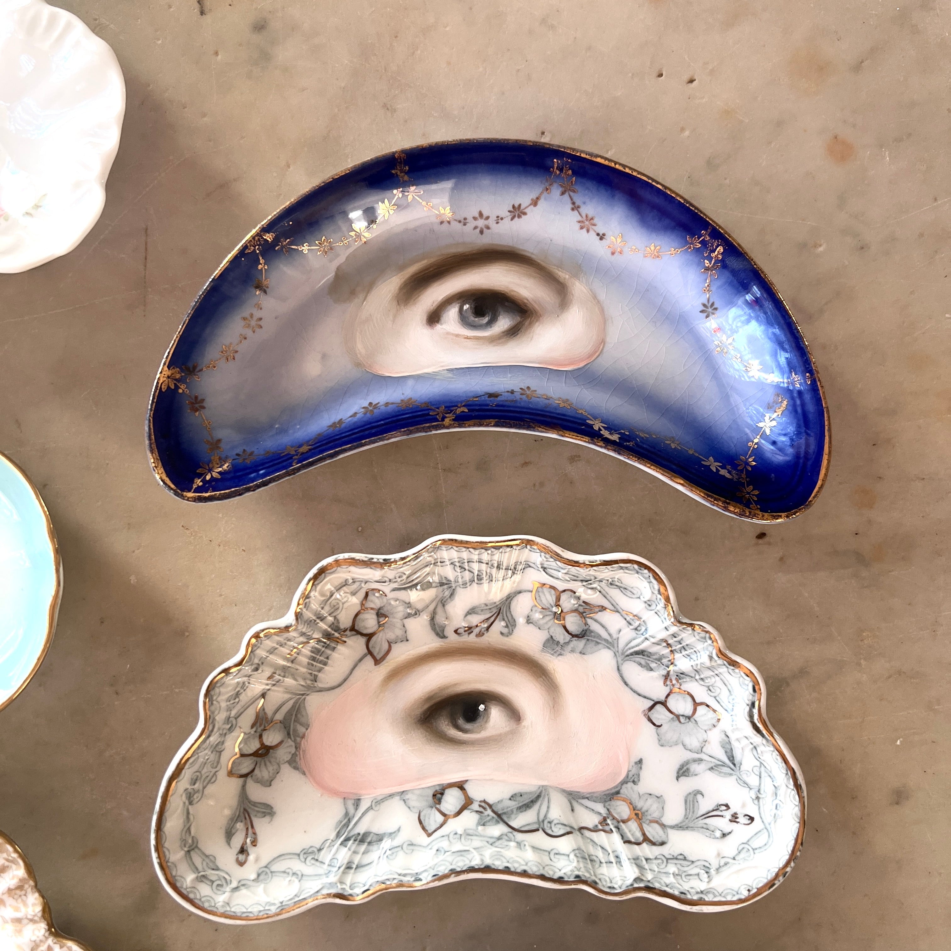 No. 3130 Lover's Eye Painting on a Blue & Gold Garland Crescent Plate