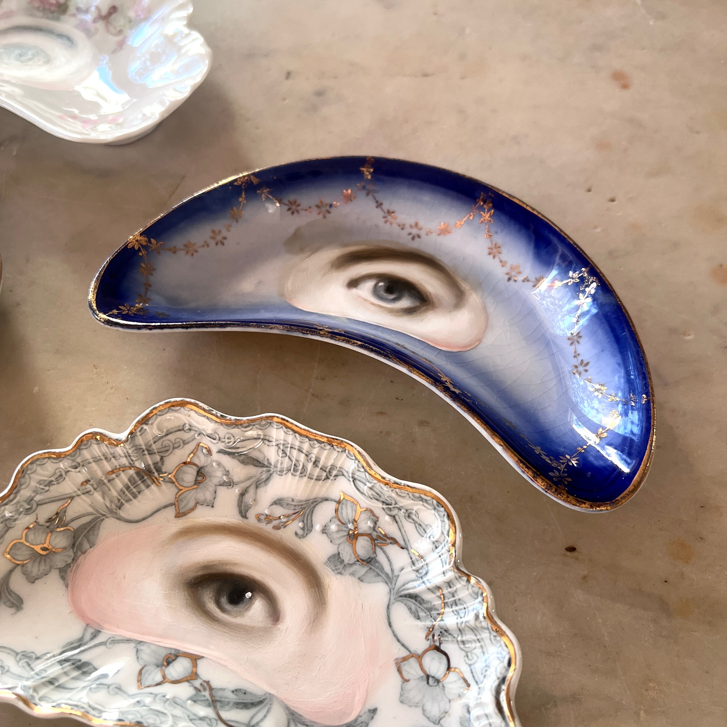 No. 3130 Lover's Eye Painting on a Blue & Gold Garland Crescent Plate