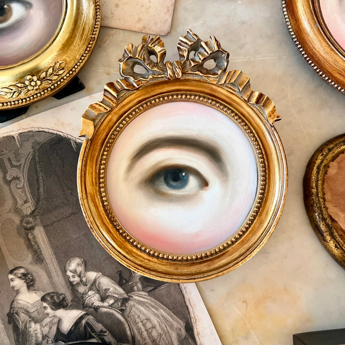 No. 2984 Lover's Eye Painting in a Gold Round Frame with Bow