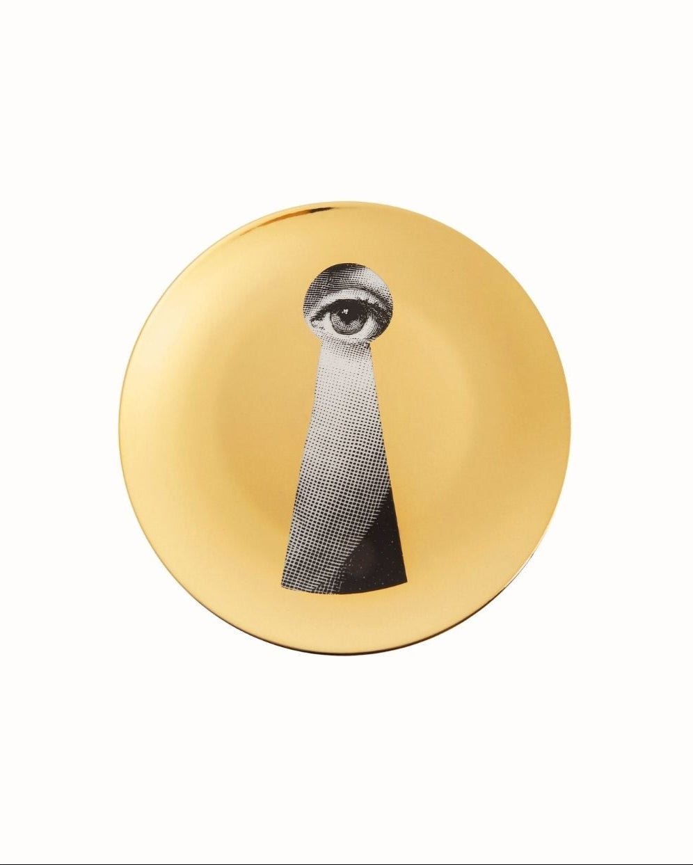 Two decorative plates with artistic face design on a gold background by Piero Fornasetti